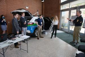 A team of Mechanical Engineering students presents their methane detection system to their faculty advisor, Neil Wright