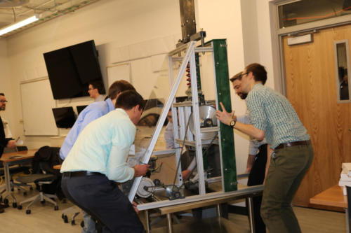 The Mechanical Engineering Fraunhofer team maneuvers their project to their presentation room