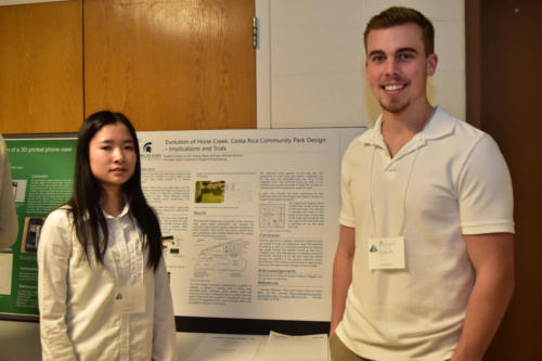 Freshman Engineering students with their project poster
