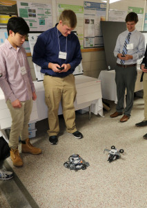 Two EGR 100 students demonstrate their robots      