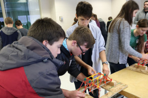 High school visitors work on their bridge building skills    